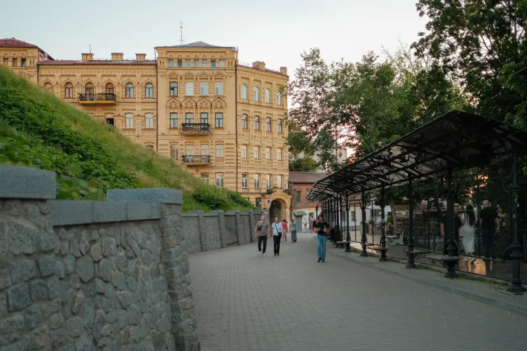 Pedestrian alley with paving stones, people, and a building in Kyiv