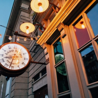 Resraurant Under Wonder - restaurant facade featuring large arched windows and an illuminated clock sign