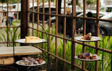 In Italy - a terrace made of wooden arches, a pile of delicacies on the table