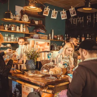 Baristas behind the counter at Vagabond Cafe in Podil, Kyiv
