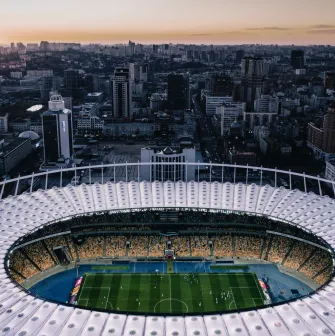 NSC Olimpiyskiy in Kyiv - stunning aerial evening view looking down into the illuminated stadium bowl