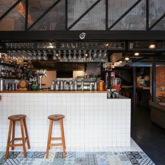 True Burger Bar - long bar counter displaying drinks and multiple beer taps
