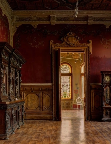 Chocolate house - hall with red walls, antique wooden furniture and stained glass windows