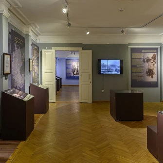 Muzei Ukrainskoi Diaspory in Kyiv - exhibition halls with grey walls and wooden parquet floors filled with historical narratives and artifacts