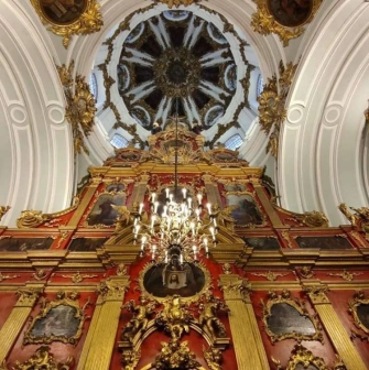 Decorated ceiling and central chandelier above the iconostasis in St. Andrew's Church in Kyiv