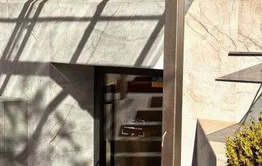 Concept 1 Boutique in Kyiv - entrance to the shop featuring a marble facade and a black sign with the logo above the glass door