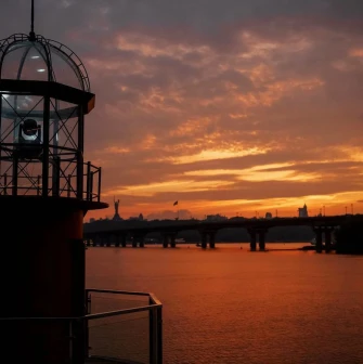Mayak - elegant, white lighthouse structure next to the river on a sunny day