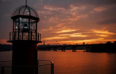 Mayak - elegant, white lighthouse structure next to the river on a sunny day