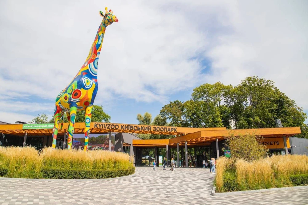 Large colorful giraffe sculpture at the entrance to the Kyiv Zoo