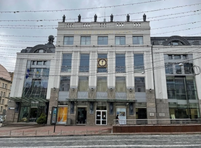 Muzei Istorii Mista Kyieva in Kyiv - modern white facade of the museum building featuring a large clock and statues on the roof
