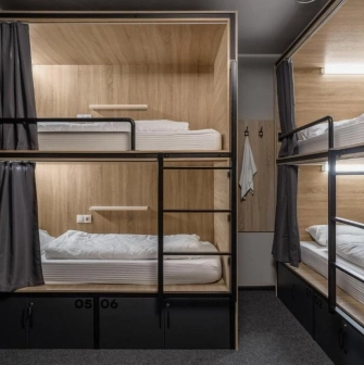 Bunk beds with lighting and curtains at Kyiv Hostel in Kyiv