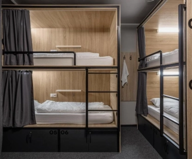 Bunk beds with lighting and curtains at Kyiv Hostel in Kyiv