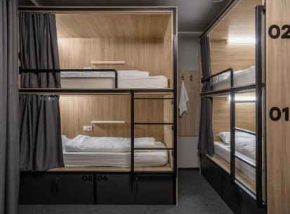 Bunk beds with lighting and curtains at Kyiv Hostel in Kyiv
