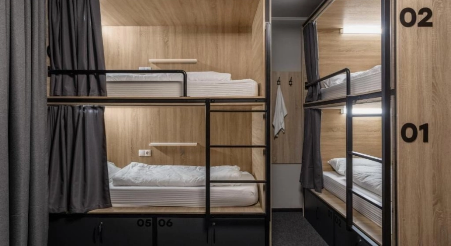 Bunk beds with lighting and curtains at Kyiv Hostel in Kyiv