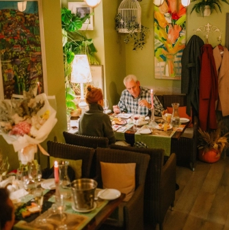 Très FRANÇAIS - intimate dining area featuring ornate decor and comfortable banquette seating