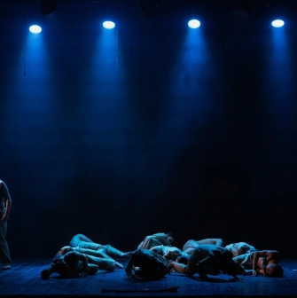 Mala Opera in Kyiv - a tense stage scene showing a lone actor and a group of performers lying on the floor