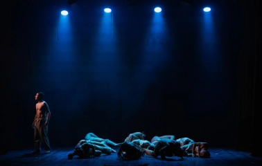 Mala Opera in Kyiv - a tense stage scene showing a lone actor and a group of performers lying on the floor