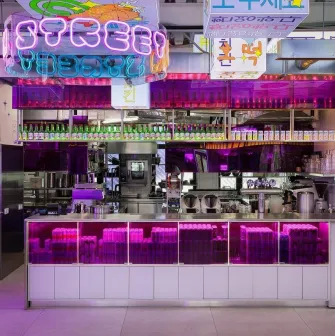 Street Kim - close-up view of the busy bar counter and serving area with many bottles