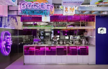 Street Kim - close-up view of the busy bar counter and serving area with many bottles