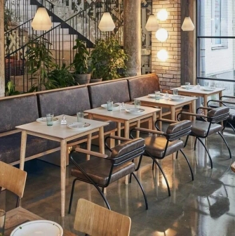 Shalom - modern dining room interior with unique wall art and low hanging lamps