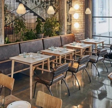 Shalom - modern dining room interior with unique wall art and low hanging lamps