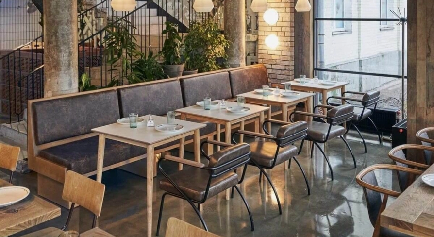 Shalom - modern dining room interior with unique wall art and low hanging lamps