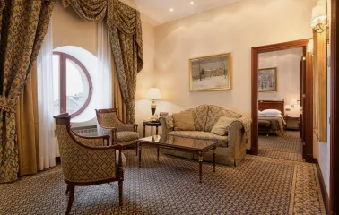 Premier Palace - elegant seating area in a hotel suite with a luxurious sofa