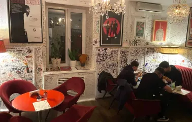 OG Burger in Kyiv - interior with red chairs and graffiti walls
