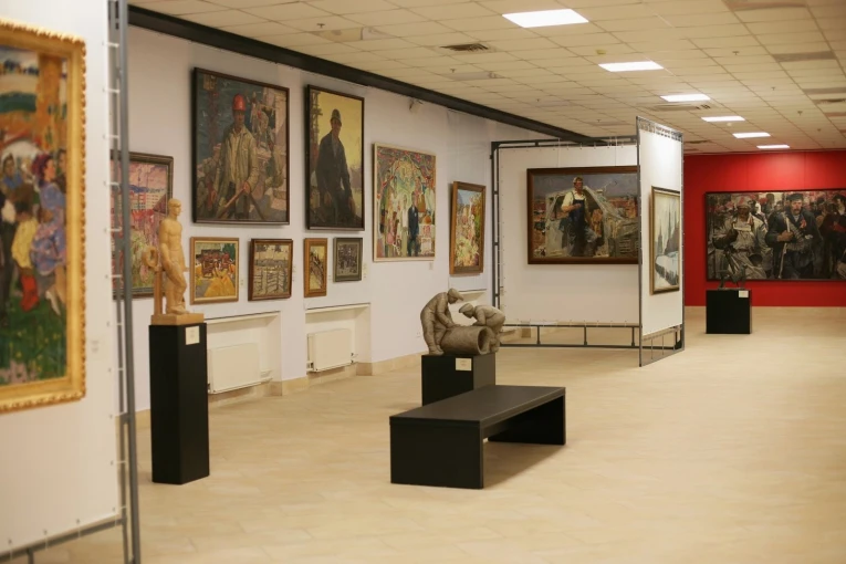 Museum of Contemporary Art in Kyiv - spacious and well-lit main gallery corridor filled with diverse paintings and small sculptures on pedestals