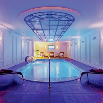 Fairmont Grand - luxurious indoor swimming pool and spa area with warm lighting