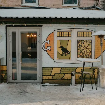 Entrance to OG Burger with street art and a snowy terrace in Kyiv