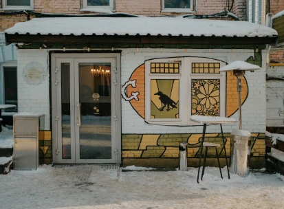 Entrance to OG Burger with street art and a snowy terrace in Kyiv
