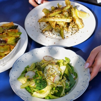 Restaurant Zigzag - three dishes on a table including a salad and asparagus