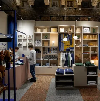 Zalizna Kramnytsia in Kyiv - stylish interior design combining modern wooden furniture and blue metal beams with the historic marble architecture of Kyiv Central Railway Station