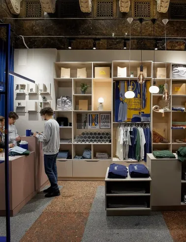 Zalizna Kramnytsia in Kyiv - stylish interior design combining modern wooden furniture and blue metal beams with the historic marble architecture of Kyiv Central Railway Station