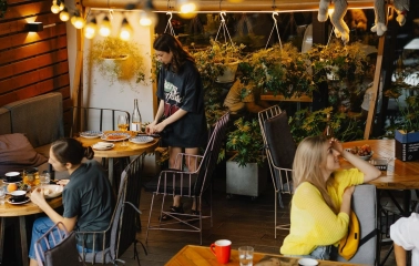 Restaurant Ulyublenyi Diadia - outdoor terrace with warm lights and customers dining