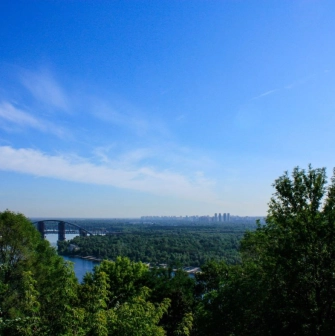 View from Volodymyrska Hill to the Dnipro River, the pedestrian bridge and the panorama of Kyiv