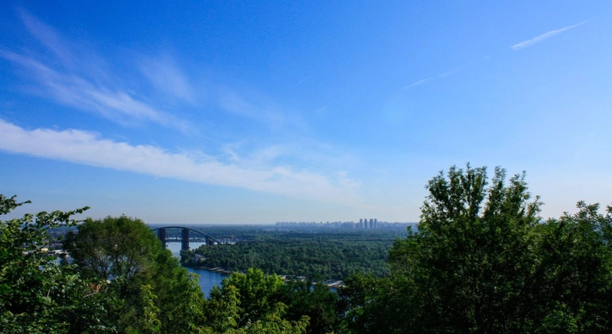 View from Volodymyrska Hill to the Dnipro River, the pedestrian bridge and the panorama of Kyiv