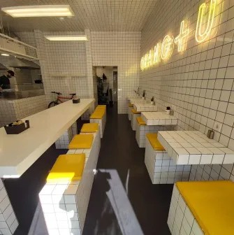 Fruit & Veg - bright interior with minimalist decor and wooden communal tables