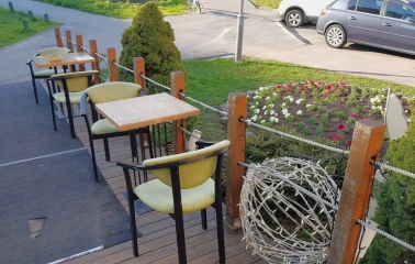Restaurant Kukhnya Polli - outdoor terrace dining area with simple tables and chairs