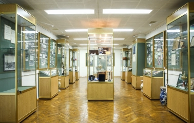 Palats Sportu in Kyiv - museum room lined with glass cases displaying golden sports trophies and memorabilia