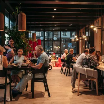 Guests at tables in the cozy interior of Fujiwara Yoshi restaurant in Kyiv