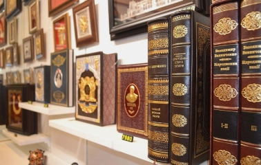Folkmart in Kyiv - close-up of leather-bound gift editions of Ukrainian history books with gold leaf details
