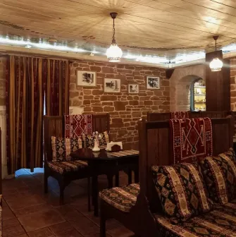 Sofra in Kyiv - dining room with wooden seats, brick walls and traditional design