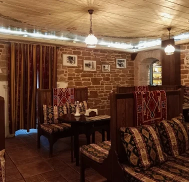 Sofra in Kyiv - dining room with wooden seats, brick walls and traditional design