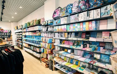 UAmade in Kyiv - store aisle where stylish backpacks are presented on the upper shelves, and various stationery items are presented below
