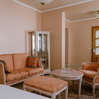 Vozdvyzhenskyi in Kyiv - classic interior with peach sofas and glass display cabinet