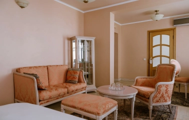 Vozdvyzhenskyi in Kyiv - classic interior with peach sofas and glass display cabinet