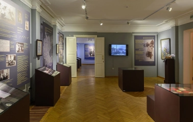 Muzei Ukrainskoi Diaspory in Kyiv - exhibition halls with grey walls and wooden parquet floors filled with historical narratives and artifacts