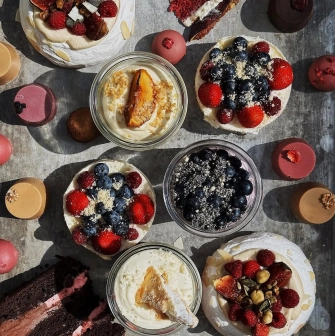 Milk Bar Tsum - close-up of a plated, stylish dessert with meringue and berries